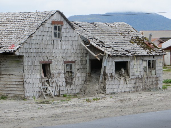 Houses covered in ash from the recent volcanic eruption in El Chaiten